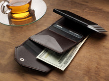 Load image into Gallery viewer, Interior view of the brown wallet with cards and cash inside the compartments. 
