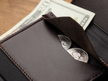 Load image into Gallery viewer, Close up to the wallet's coin pocket with change and bills inside. 
