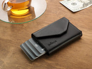 Front view of the black wallet with six credit cards peeking from the side. 