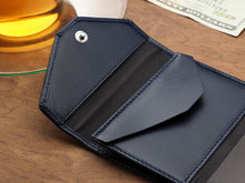 Load image into Gallery viewer, Close up to the change pocket in the navy wallet. 
