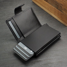 Load image into Gallery viewer, Interior view of the black wallet with six credit cards peeking from the aluminum case 
