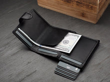 Load image into Gallery viewer, Interior view o the wallet with credit cards and a $100 bill tucked into the pockets. 
