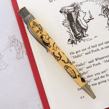 Load image into Gallery viewer, The pen featuring E.H. Shepard&#39;s classic black line art illustrations of beloved animal characters on a honey-colored barrel with antique brass accents.
