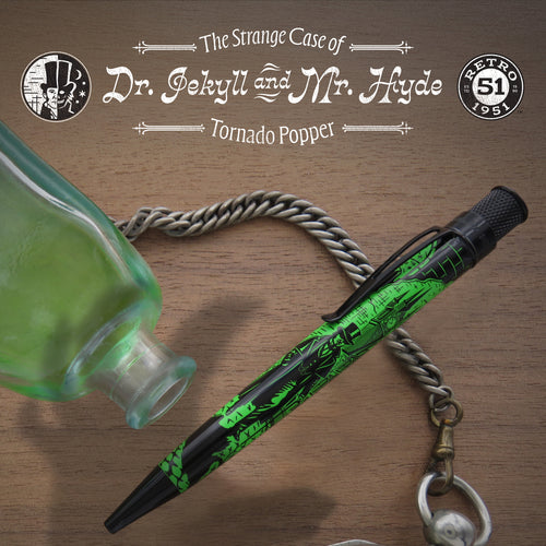 The pen arranged with a chain and a green bottle on wooden texture. 
