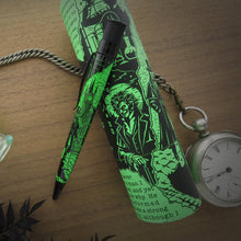 Load image into Gallery viewer, Side view of the pen leaning on its gift tube packaging. 
