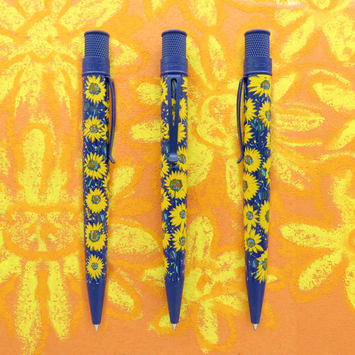 Front and side views of the pen, set on an orange background with yellow hand-drawn flowers. The pen is blue with matching blue trims. The design features a series of Sunflowers around it.
