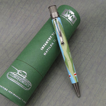 Load image into Gallery viewer, The Pen sits on top of the green presentation tube with a grey background.

