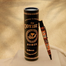 Load image into Gallery viewer, A black cylindrical tube labeled 'the ODYSSE HOMER' stands upright on draped white fabric, with a matching decorative pen resting beside it against a warm beige sand-textured background.
