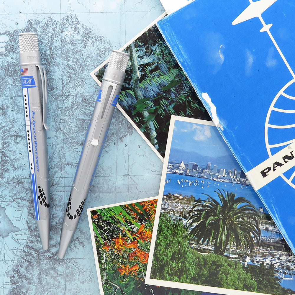 Two rollerball pens, both sit on the background, made of postcards and a map.