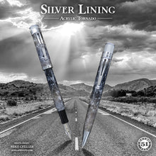 Load image into Gallery viewer, Two acrylic tornado pens on a road with mountains and clouds in the background, labeled 'Silver Lining'.
