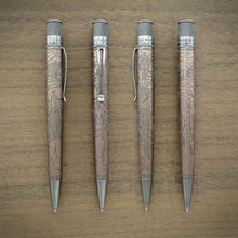 Load image into Gallery viewer, Four views of the pen with acid-etched bison patterns on a brown wood-grain background.
