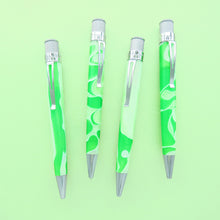 Load image into Gallery viewer, Four different views of the green and white acrylic rollerball with chrome accents on a light green background.
