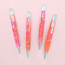 Load image into Gallery viewer, Four different views of the pink and orange acrylic rollerball with chrome accents on a light pink background.
