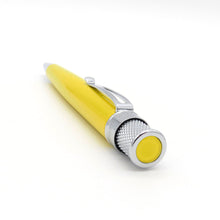 Load image into Gallery viewer, Angled top view of a yellow retractable pen with a polished chrome top, clip and tip. The top of the pen has a matching yellow disk. 
