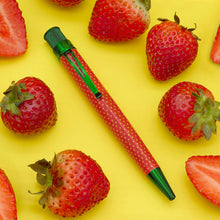 Load image into Gallery viewer, Front view of the Strawberry pen on a yellow background surrounded by fresh Strawberries. 
