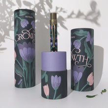 Load image into Gallery viewer, Front view of the Growth pen with two matching pen gift tubes on a grainy white background. 

