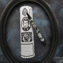 Load image into Gallery viewer, The Picture of Dorian Gray by Oscar Wilde themed pen and gift tube displayed inside a black oval frame on a dark textured blue background. 
