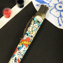 Load image into Gallery viewer, Close up to the side of the tattoo designs on the side of the pen. 
