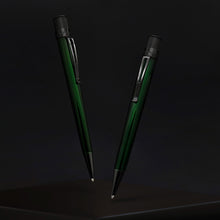 Load image into Gallery viewer, Two green pens with black stealth accents on a dark background.
