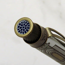 Load image into Gallery viewer, A close-up of the top disc with a brass-toned cap featuring a black and white geometric pattern, set against a light marble background.

