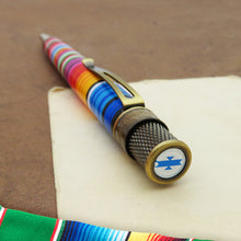 Load image into Gallery viewer, A close-up of the top disc of the rollerball pen on a cream and brown background.

