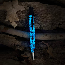 Load image into Gallery viewer, Blue glow in the dark feature with wolf  design on a wooden surface
