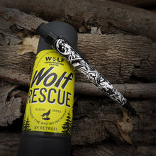 Load image into Gallery viewer, Wolf Rescue pen displayed on graphic tube on a wooden background
