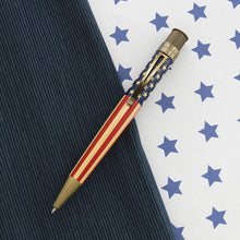 Load image into Gallery viewer, Front view of the rollerball pen. Placed on a textured blue background split by a white background with stars.
