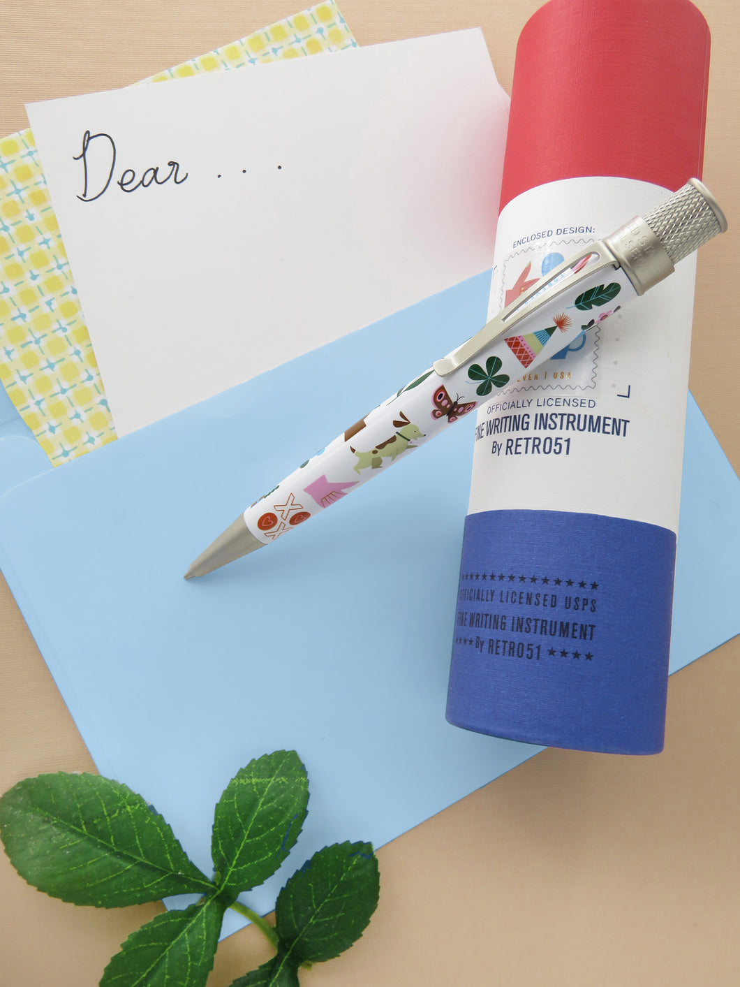 Retro 51 USPS® Thinking of You Stamp 2023 Rollerball Pen with Presentation Tube, and giftcard background.