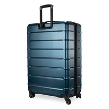 Load image into Gallery viewer, Angled back panel view of a navy blue suitcase with black accents. 
