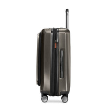 Load image into Gallery viewer, Side panel view of the hard shell graphite suitcase. It features a grab handle. 
