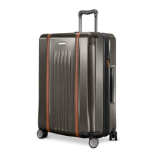 Load image into Gallery viewer, Angled front panel view of the graphite hard shell suitcase. 
