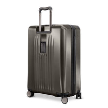 Load image into Gallery viewer, Angled back panel view of the graphite hard shell suitcase. 
