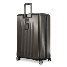 Load image into Gallery viewer, Angled back panel view of the graphite hard shell suitcase. 
