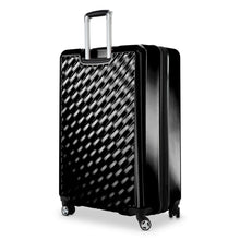 Load image into Gallery viewer, Angled back panel view of the black hard shell suitcase. 
