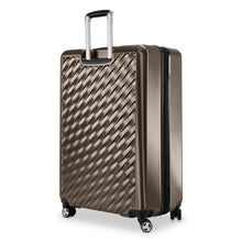 Load image into Gallery viewer, Angled back panel view of the bronze hard shell suitcase. 
