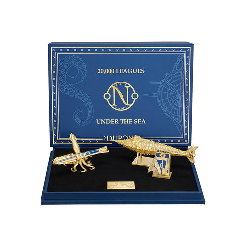 Gold submarine model and squid figure on a blue display box with '20,000 Leagues Under the Sea' text.