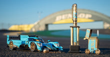 Load image into Gallery viewer, The collector&#39;s edition items arranged on a race track. 
