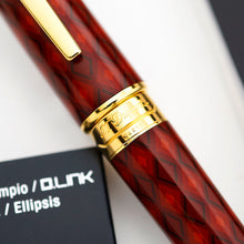 Load image into Gallery viewer, A close-up of the ring of the pen, engraved with the brand name 'S.T. Dupont', resting on a white surface.
