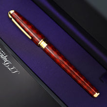 Load image into Gallery viewer, A close-up of the rollerball pen with gold accents, resting diagonally on a purple-lined presentation box.
