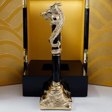 Load image into Gallery viewer, Side view of the pen on the stand. The presentation box stands opened behind it. 
