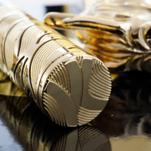 Load image into Gallery viewer, Close up to the bottom of the pen with engraved decorations.
