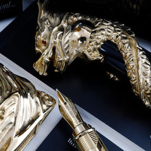 Load image into Gallery viewer, Close up to the arranged fountain pen nib, stand, cap, and paperwork. 
