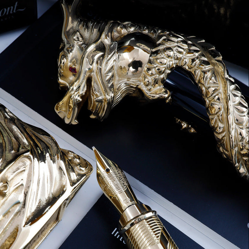 Close up to the arranged fountain pen nib, stand, cap, and paperwork. 