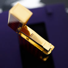 Load image into Gallery viewer, A close-up of the lighter, shown open against a dark purple background.
