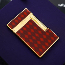 Load image into Gallery viewer, The front of the lighter with a red and brown argyle-patterned body, on a purple surface.

