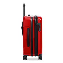 Load image into Gallery viewer, Side panel view of the red suitcase with black accents. It features a grip handle and a three-digit combination lock. 
