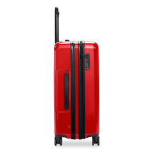 Load image into Gallery viewer, Side panel view of the red suitcase with black accents. It features a grip handle and a three-digit combination. 
