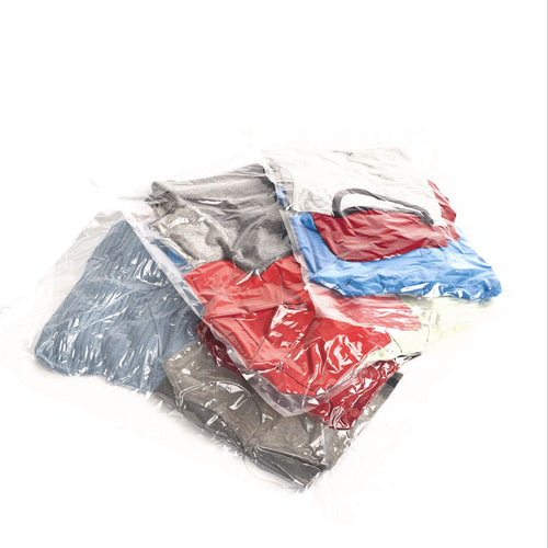 Three transparent compression bags filled with folded clothes, compressed. 
