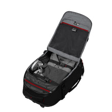 Load image into Gallery viewer, Angled view of the backpack with the main compartment holding clothes and a pair of shoes. 
